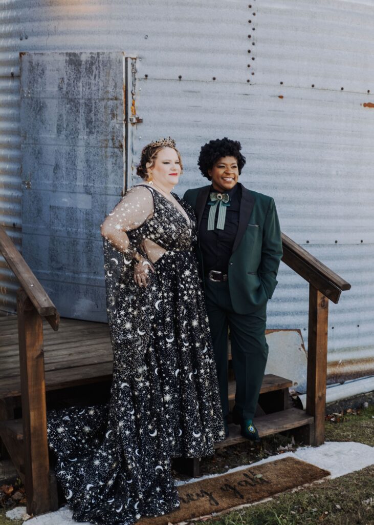two brides post together on rustic barn stairs of Starlight Meadow wedding venue
