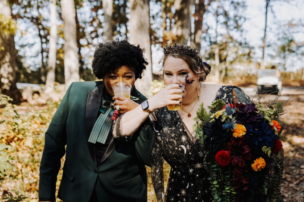 two brides toasting at their outdoor Starlight Meadow wedding
