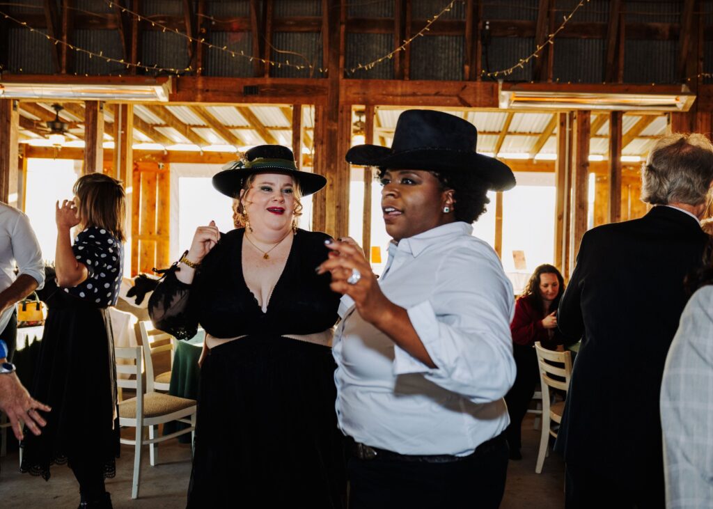 two brides dancing at their wedding reception at Starlight Meadow in Burlington NC