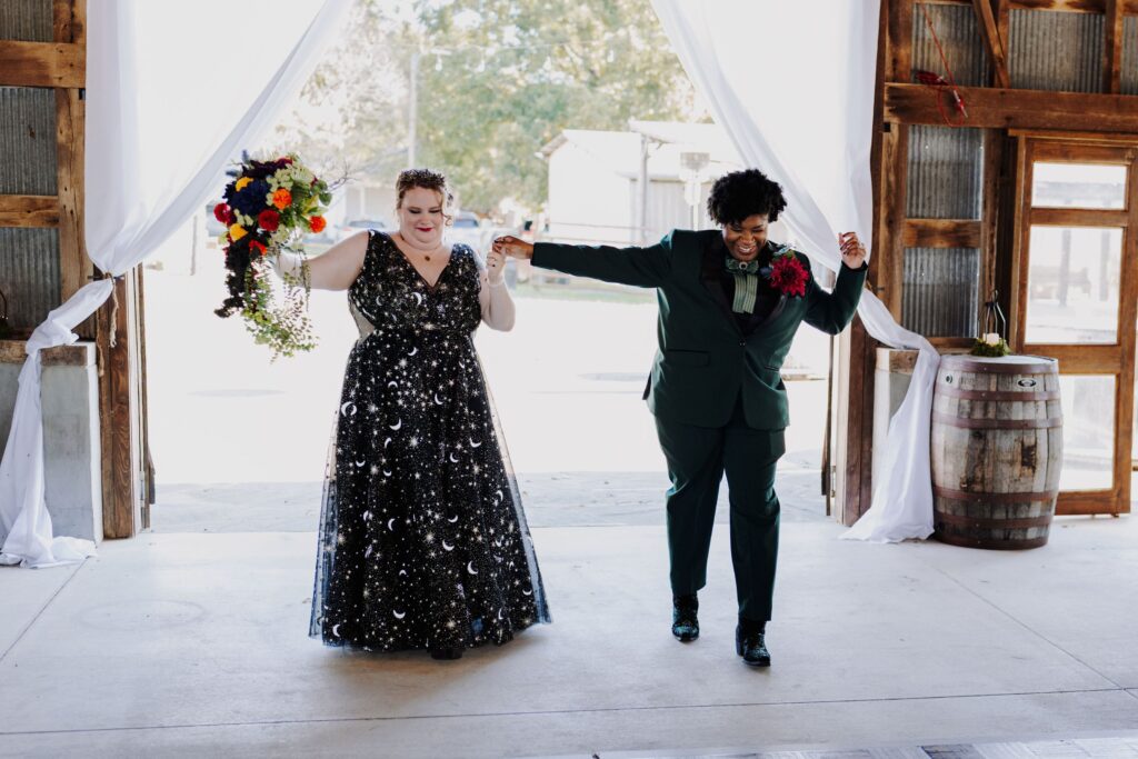 two brides dancing into their wedding reception at Starlight Meadow in Burlington NC