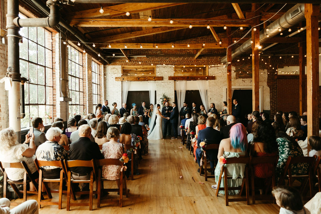 Kristen & Tommy's indoor ceremony in Forest Hall's historic mill space.
