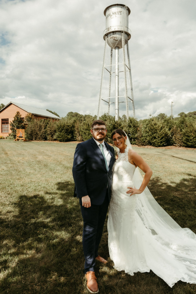 Kristen & Tommy outside Forest Hall, with the Chatham Mills water tower behind them.